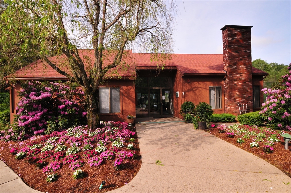 3 Post Oak Lane, Unit 9 Natick, MA 01760 - Photo 29 of 30 a front view of a house with a yard and fountain in middle of the house