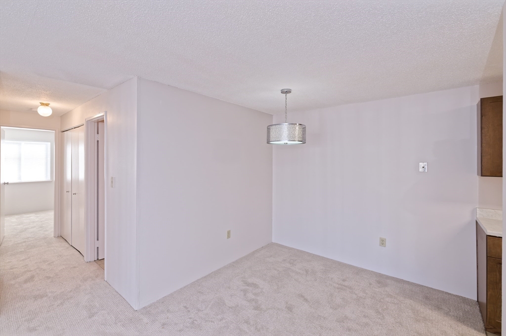3 Post Oak Lane, Unit 9 Natick, MA 01760 - Photo 7 of 30 an empty room with a empty space and a ceiling fan