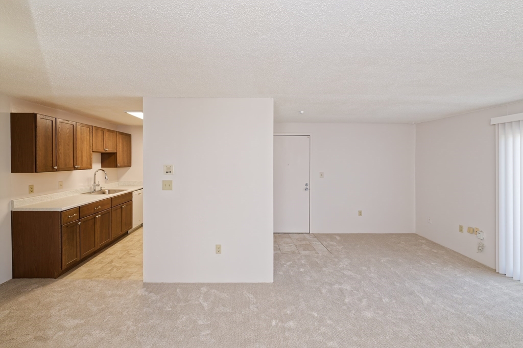 3 Post Oak Lane, Unit 9 Natick, MA 01760 - Photo 9 of 30 a view of a kitchen with sink cabinets and a window