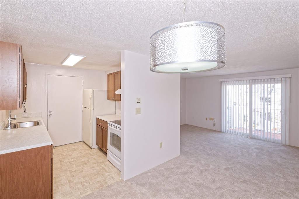 3 Post Oak Lane, Unit 9 Natick, MA 01760 - Photo 10 of 30 a view of a kitchen cabinets and empty room
