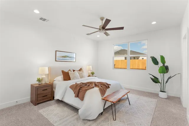 a bedroom with a bed table and a couch