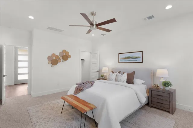 a bedroom with a bed and a ceiling fan