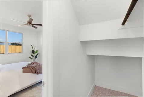 a bedroom with a bed and a potted plant