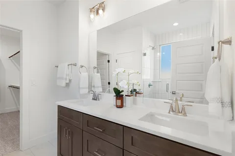 a bathroom with double vanity sink and a mirror
