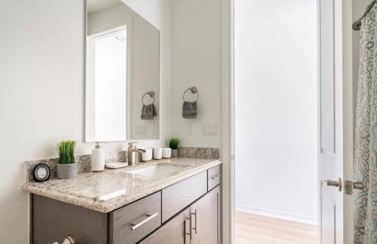 3231 Real Street, Unit B Houston, TX 77087 - Photo 21 of 25 a bathroom with a granite countertop sink and a mirror