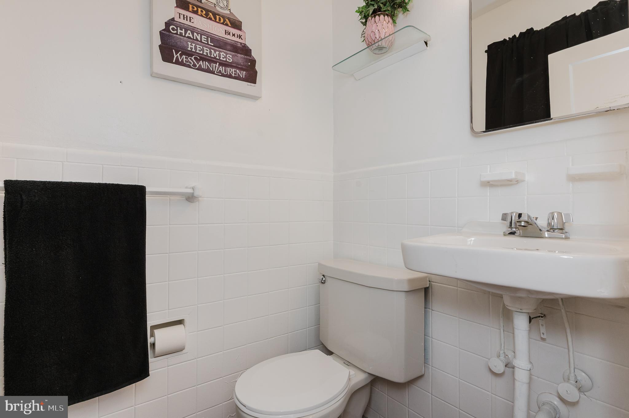 4023 Fallstaff Road Baltimore, MD 21215 - Photo 8 of 22 a white toilet sitting next to a bathroom sink