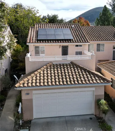 an aerial view of a house with a yard and balcony