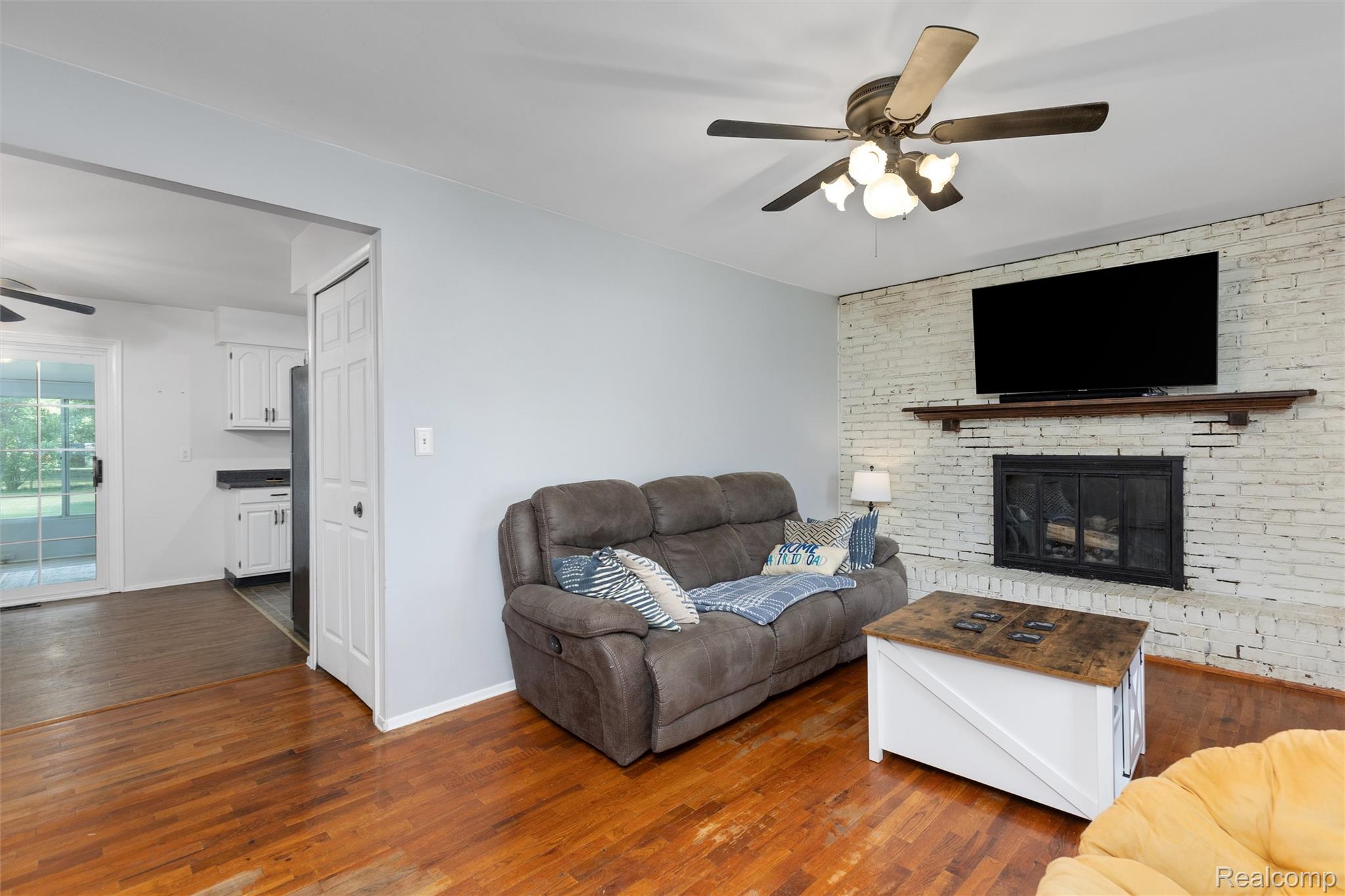 4497 Reid Road Swartz Creek, MI 48473 - Photo 3 of 31 Light gray painted walls complementing rich wood-finish flooring