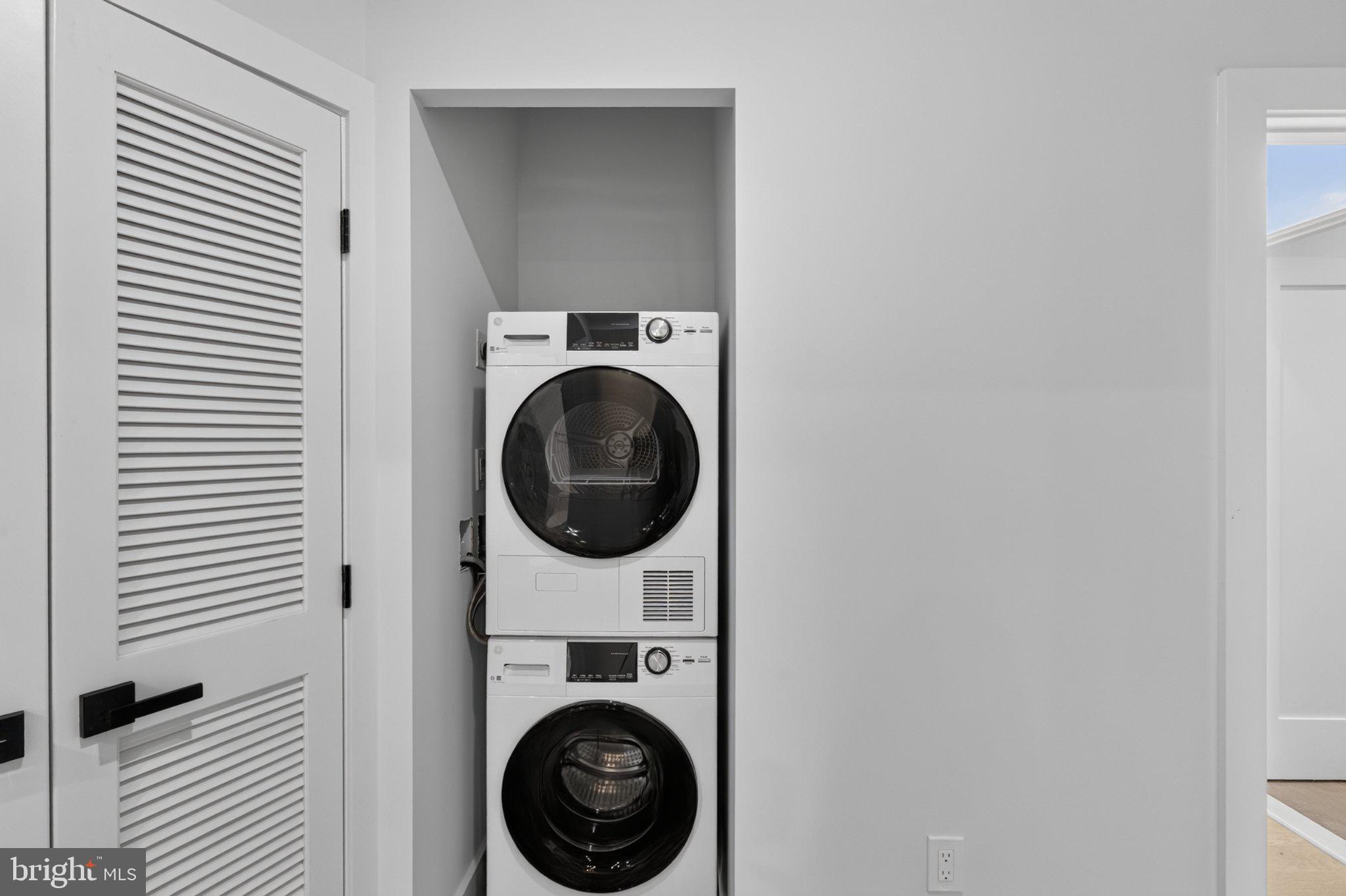 1650 Columbia Road Northwest, Unit 402 Washington, DC 20009 - Photo 18 of 19 Sleek laundry nook for modern living.