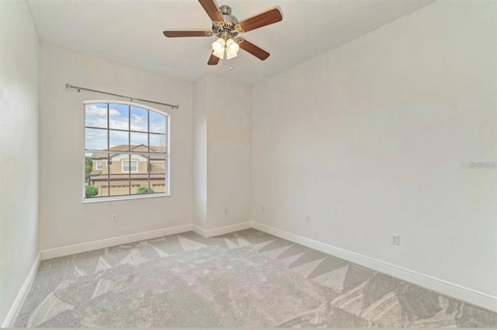 8261 Miramar Way, Unit 202 Lakewood Ranch, FL 34202 - Photo 22 of 36 an empty room with a window and a fan