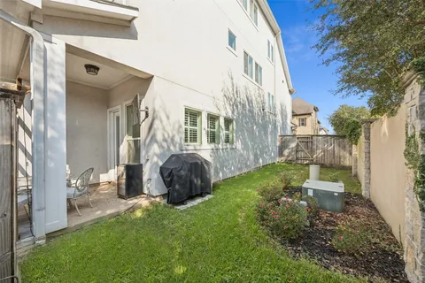 a view of a chair and table in the back yard