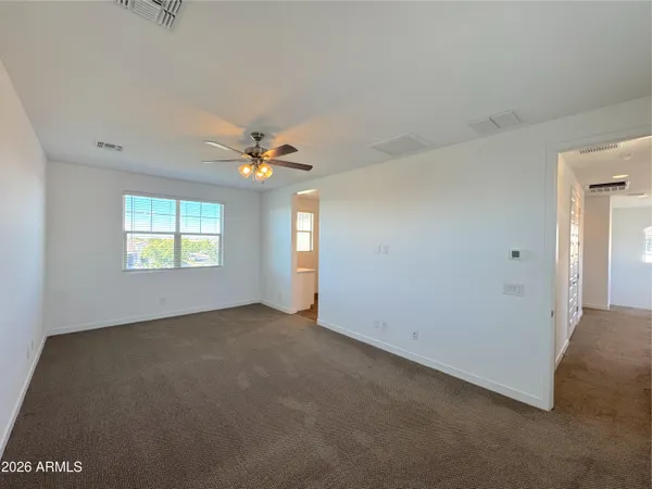 an empty room with windows and closet