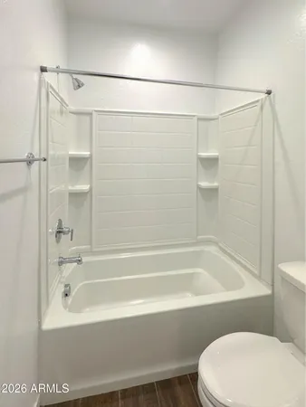 a bathroom with a shower and a toilet