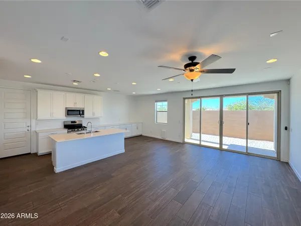 a view of kitchen with sink and wooden floor