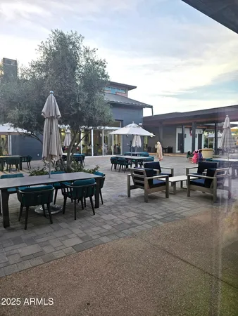 a view of a patio with dining table and chairs