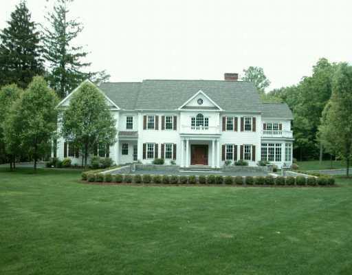 235 Hollow Tree Ridge Road Darien, CT 06820 - Photo 1 of 1 a front view of a house with a garden and trees