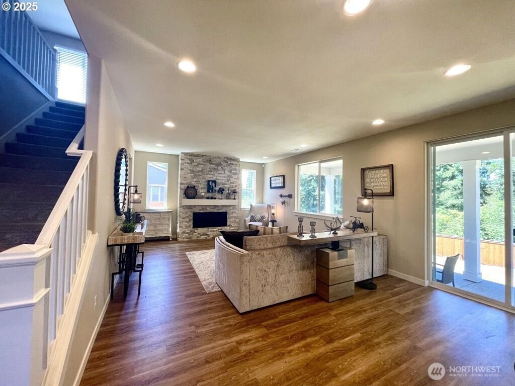 709 North Kemper Loop Ridgefield, WA 98642 - Photo 7 of 25 a living room with fireplace furniture and a wooden floor