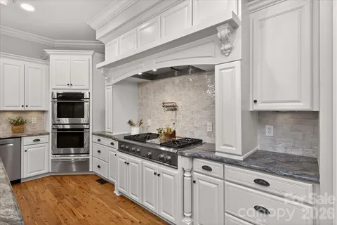a kitchen with granite countertop a stove and a sink