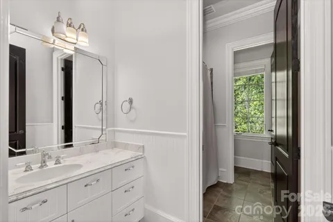 a bathroom with a double vanity sink and a mirror