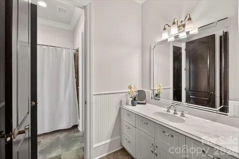 a bathroom with a double vanity sink and a mirror