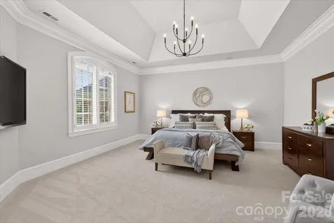 a bedroom with bed and window with lamp
