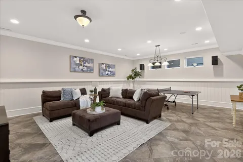 a living room with furniture and kitchen view