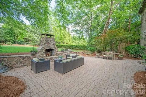 a view of a patio with table and chairs and potted plants