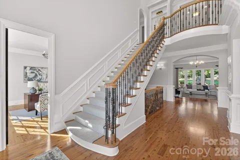 a view of entryway and hall with wooden floor