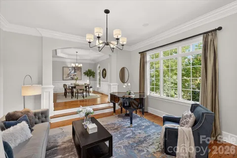 a living room with furniture a chandelier and a window