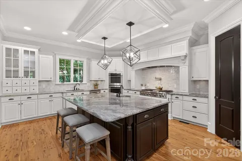 a kitchen with granite countertop a sink and cabinets