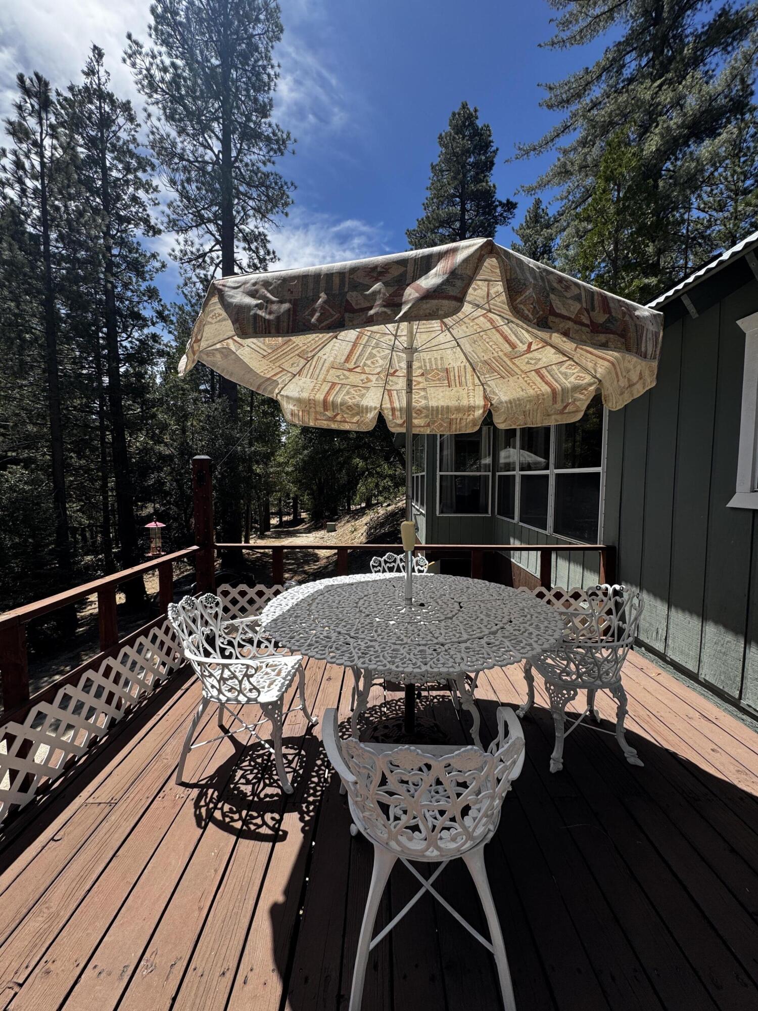 52670 Forest Rte 4S02 Idyllwild, CA 92549 - Photo 2 of 51 a view of a patio with table and chairs with wooden floor and fence