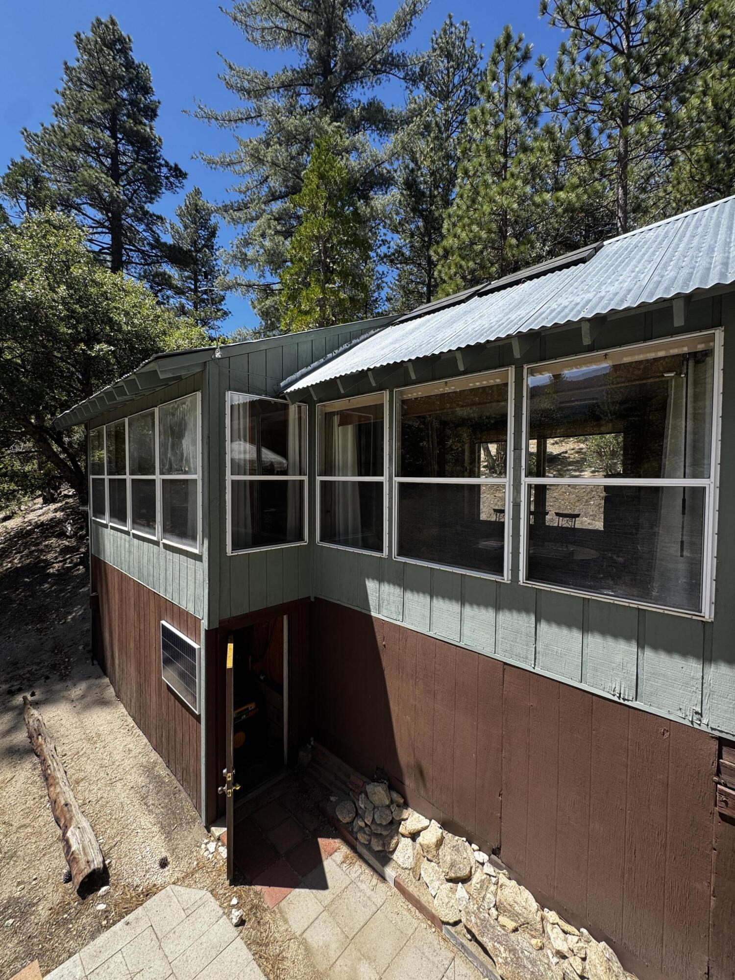52670 Forest Rte 4S02 Idyllwild, CA 92549 - Photo 3 of 51 a view of a house with a large window and wooden fence