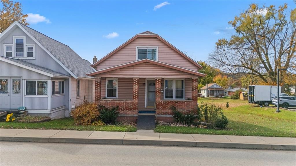 3144 Leechburg Road Lower Burrell, PA 15068 - Photo 1 of 47 a front view of a house with a yard and porch