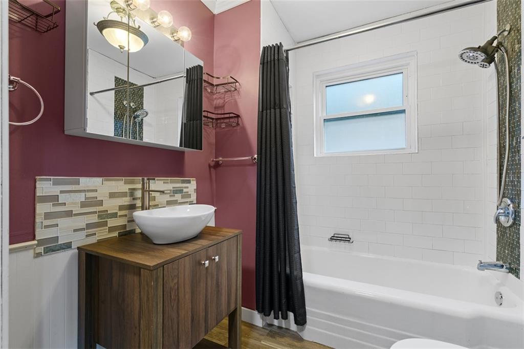 3144 Leechburg Road Lower Burrell, PA 15068 - Photo 17 of 47 a bathroom with a sink a mirror and a bathtub