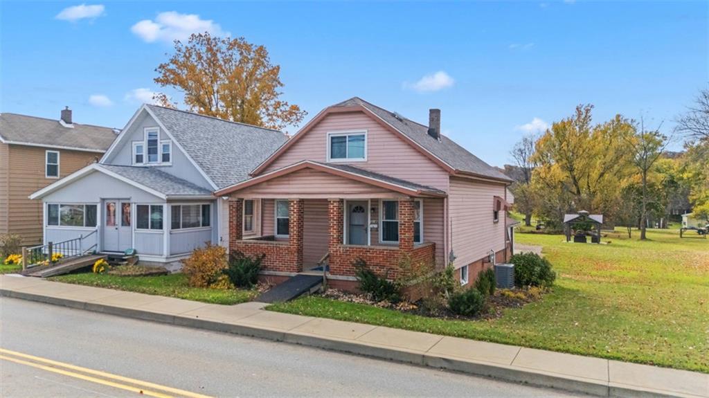 3144 Leechburg Road Lower Burrell, PA 15068 - Photo 2 of 47 a front view of a house with a yard and potted plants