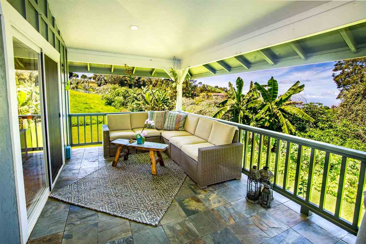 180 Waiakoa Road Kula, HI 96790 - Photo 18 of 27 a balcony with wooden floor and outdoor seating