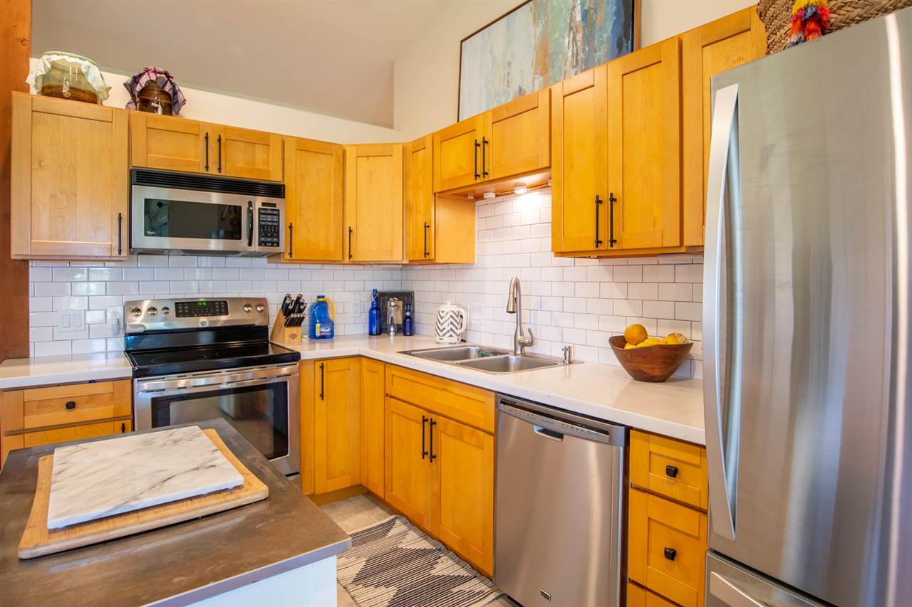 180 Waiakoa Road Kula, HI 96790 - Photo 10 of 27 a kitchen with stainless steel appliances a stove a sink and a microwave