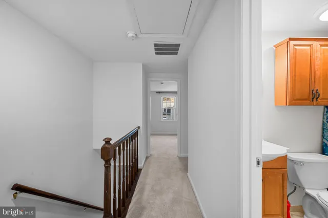 a view of a hallway with wooden floor and entryway