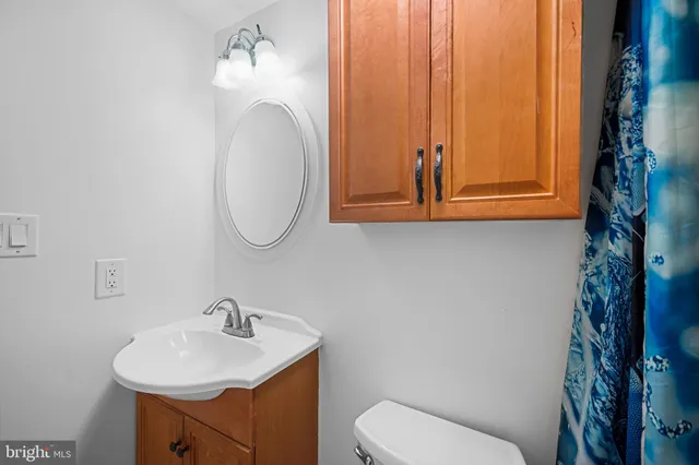 a bathroom with a toilet sink and mirror