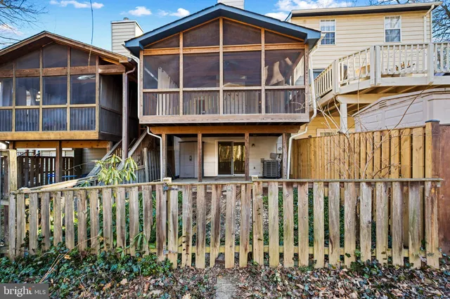a view of a house with wooden fence