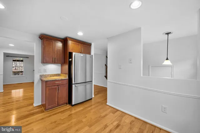 a kitchen with a refrigerator and a stove top oven