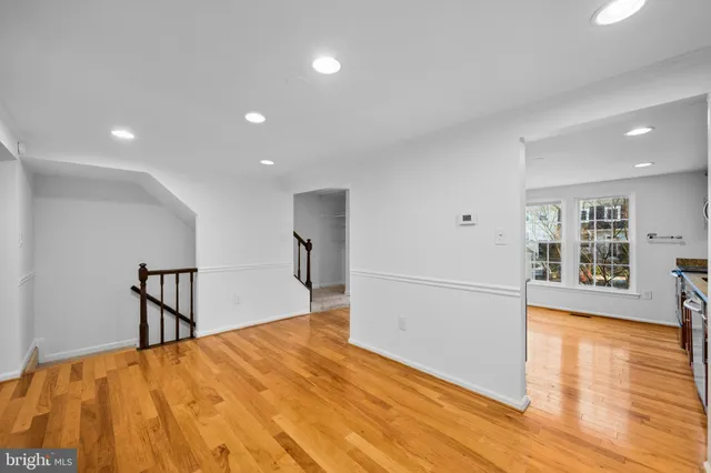 a big room with wooden floor and natural light