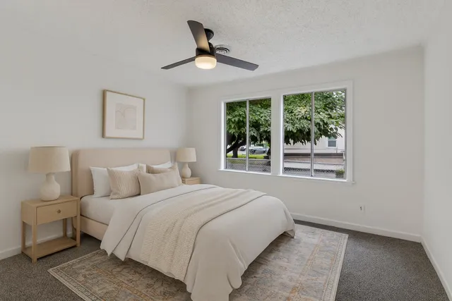 a bedroom with a large bed and a large window