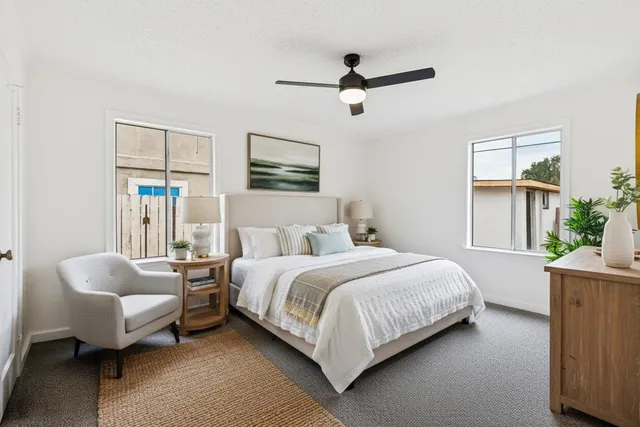 a bedroom with a bed couch and a window