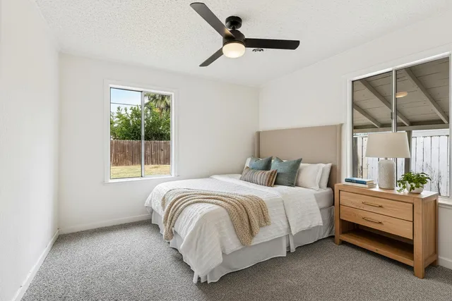 a bedroom with a bed and a window