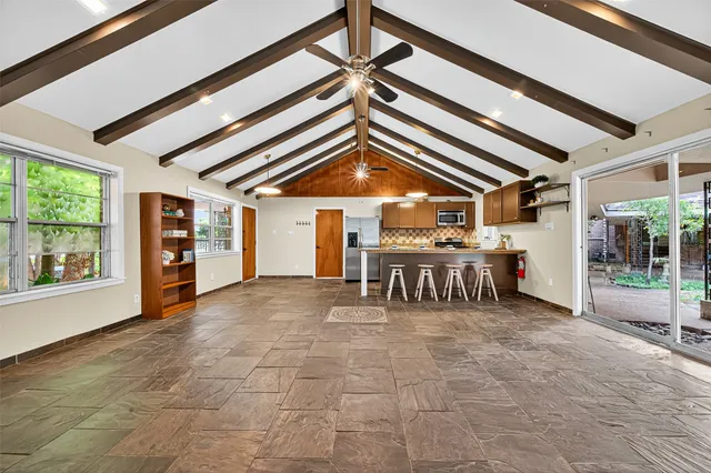 a view of a chairs and table in a room next to a window