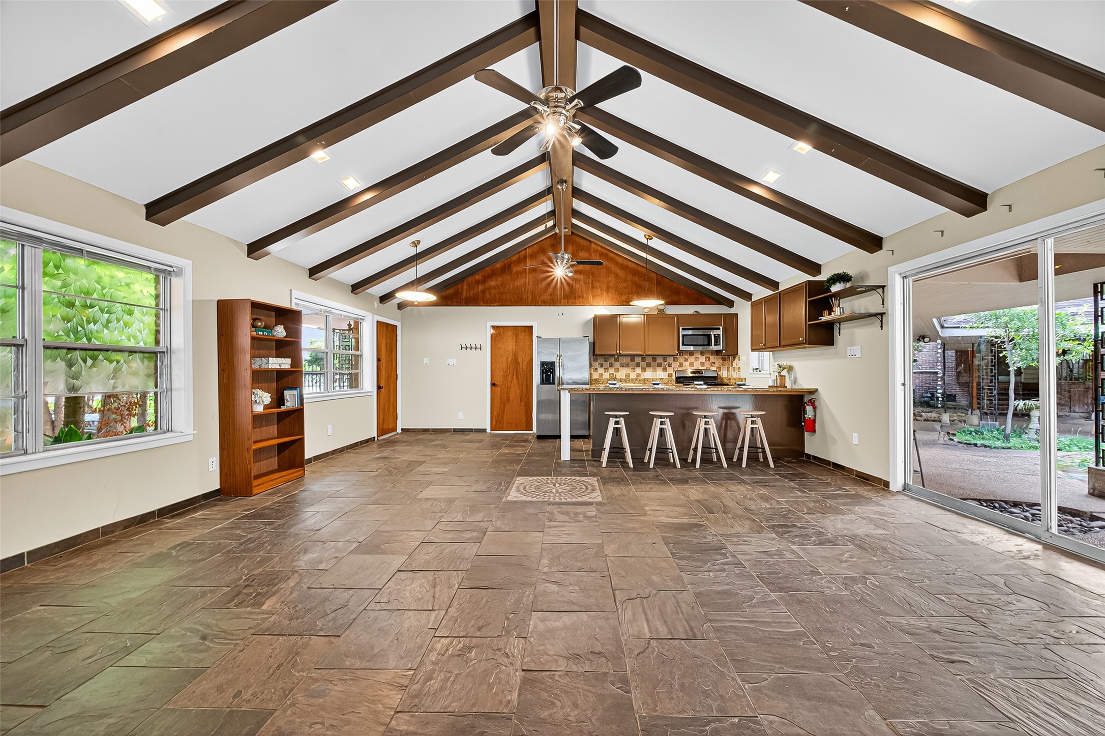 Large living space with open kitchen. Views of the backyard and koi pond.