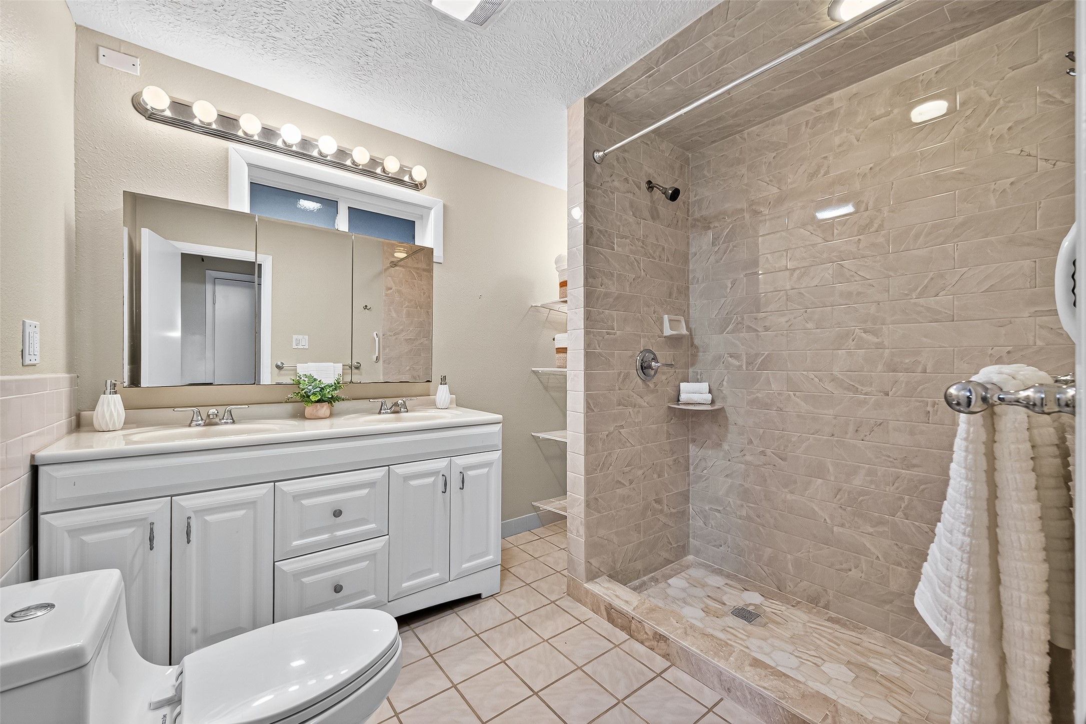 4628 Roseneath Drive, Unit A Houston, TX 77021 - Photo 7 of 15 Hall bathroom with large walk in shower and double vanities. Remodeled with upgraded marble and porcelain tile.