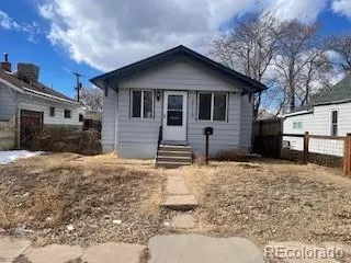a front view of a house with a yard covered in snow