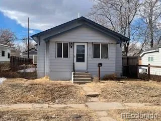 a front view of a house with a yard covered in snow